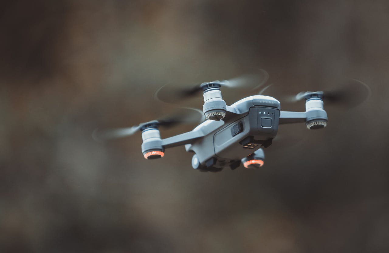 why-choose-us A detailed close-up of a drone flying in an outdoor setting, showcasing its design and technology.